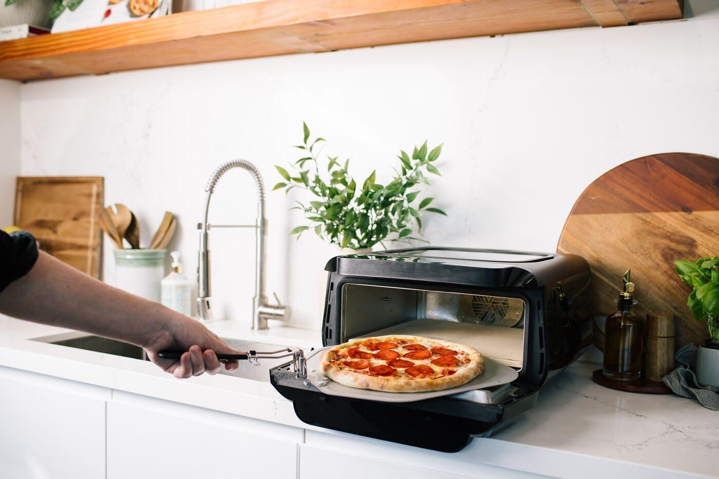 image:imageFrigidaire Electric Indoor Pizza Oven Reach Temperatures of 700F Stone Bake 12 Pizzas in Minutes Portable Countertop Oven with Air Fry and Bake Peel Included Model FRPO100BWith Pizza Peel Pizza Cutter